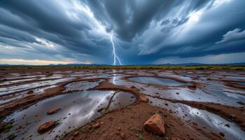 a storm washed plain with pools of reflective water catching glimpses of lightning in the clouds. photo