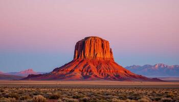 a lone butte rising from a flat prairie, its red rock sides gleaming beneath a wide open sky. photo