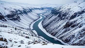 a frozen river winding through a deep valley surrounded by snow covered slopes. photo