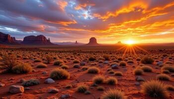 a vast desert plain with scattered boulders and distant rocky mesas silhouetted by sunset. photo