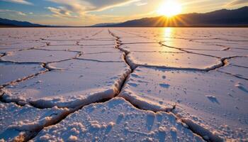 a broad salt flat cracked into intricate patterns and reflecting the late afternoon sun. photo