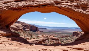red rock arch framing the distant desert horizon photo