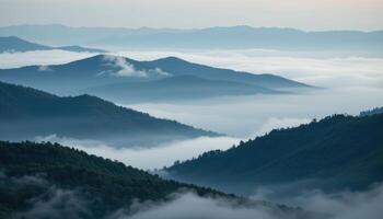fog drifting through layers of dark green hills photo