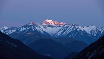 a moonlit mountain landscape with snow peaks glowing softly. photo