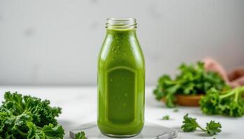 a bright green kale smoothie in a clear bottle. photo