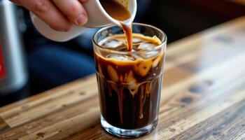 a cup of vietnamese iced coffee dripping into a glass. photo