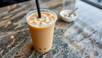 a creamy thai iced tea in a plastic cup. photo