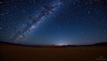 a night sky full of stars above a calm desert plain. photo