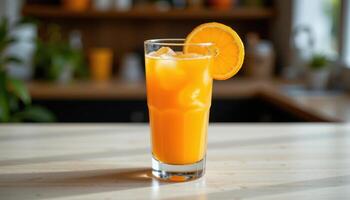 a tall glass of orange juice with ice cubes. photo