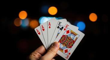 Person holding playing cards with aces and kings, depicting a game of poker or chance. photo