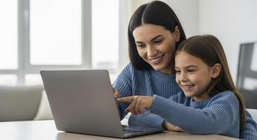 Smiling mother and daughter engaging with a laptop, pointing at the screen during shared activity at home. photo