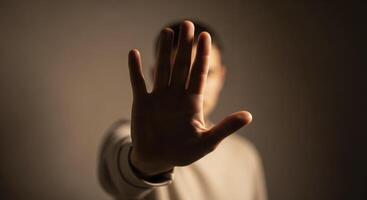 Human hand held up with palm facing forward, signaling stop, refusal, and boundary. photo