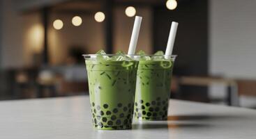 Two vibrant matcha bubble tea drinks with tapioca pearls and ice in clear cups on a cafe table. photo
