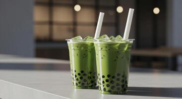 Two refreshing matcha bubble tea drinks with tapioca pearls and ice in clear plastic cups. photo
