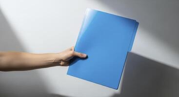 Human Hand Holding Blue Folder for Business, Document Management, and Professional Use photo