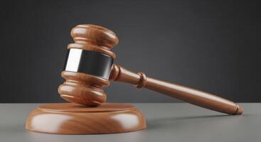 Wooden judge gavel with silver band on a sound block, symbolizing justice and law. photo