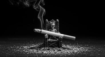 Monochrome image of a lit cigarette on a skeleton king throne with ash and smoke photo