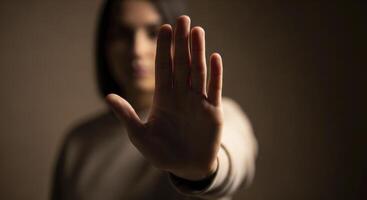 Person hand held up with palm facing forward, signaling stop, refusal, or boundary. photo