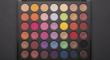 Professional top down view of a large makeup palette with many colorful eyeshadow pans photo