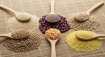 Healthy dry grains and seeds assortment with wooden spoons on a bamboo mat for nutrition photo