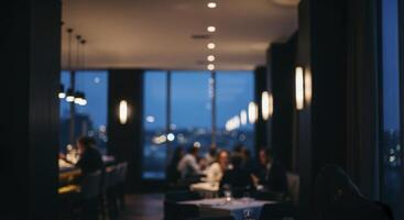 Blurred scene inside a contemporary high end restaurant during the evening with patrons dining photo