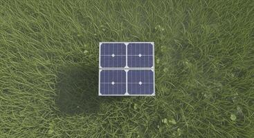 Overhead view of a small square solar panel array on green grass for renewable energy photo