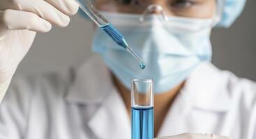 Scientist conducting a precise experiment in a laboratory with blue liquid and a test tube. photo