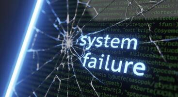 Shattered computer screen displaying system failure text with glowing blue light and code photo