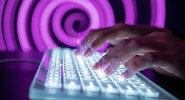 Hands typing on a glowing futuristic keyboard with digital effects and purple spiral background photo
