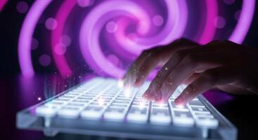 Hands typing on a glowing transparent keyboard with abstract purple technology background photo