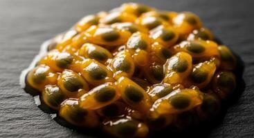 Close Up Macro View of Vibrant Passion Fruit Pulp and Seeds on a Dark Background photo