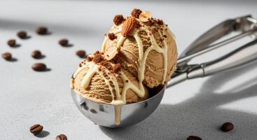 Creamy coffee ice cream scoops with white chocolate and nuts in a metal scoop photo