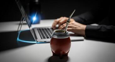 Traditional Mate Gourd and Laptop on a Desk for Modern Productivity photo