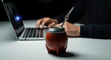 Mate Gourd and Laptop on Desk Symbolizing Modern Productivity and Traditional Culture photo
