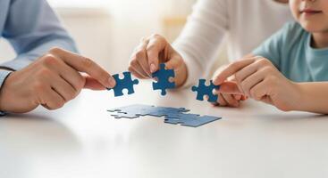 Family hands assembling a blue puzzle, symbolizing teamwork and problem solving photo