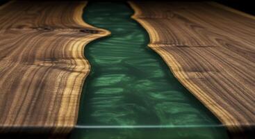 Emerald green resin river flowing through a live edge walnut wood tabletop with polished surface photo