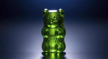 Vibrant Green Gummy Bear Candy with Translucent Glossy Finish on Dark Background photo