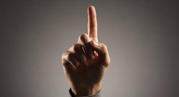 Human hand with index finger pointing upwards indicating direction or number one photo