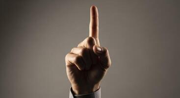 Human Hand with Index Finger Pointing Upwards Symbolizing Direction or Number One photo