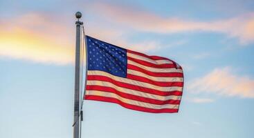 American flag proudly waving on a flagpole against a vibrant sky with soft clouds photo