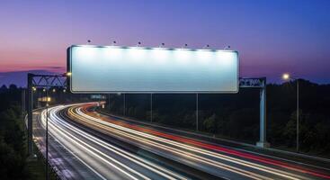 Blank Illuminated Billboard Over a Busy Highway with Streaks of Light at Twilight photo
