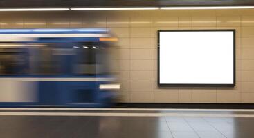 Subway Train in Motion Blurs Past Blank White Billboard at Underground Station photo