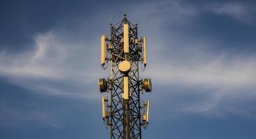 Communication Tower with Antennas Against Blue Sky for Global Network Connectivity photo