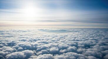 Aerial view of a vast cloudscape stretching to the horizon under a bright blue sky photo
