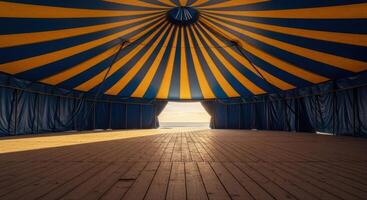 Empty Grand Circus Tent Interior with Blue and Yellow Striped Ceiling and Wooden Floor photo
