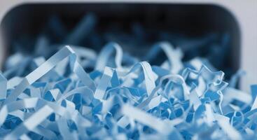Close up of light blue shredded paper showing thin curled strips and abstract texture photo