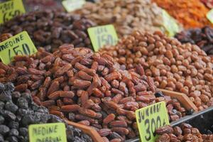 Fresh dates and dried fruits displayed at market stall photo