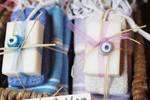 Beautifully wrapped handmade soaps in a basket display photo
