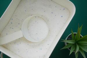 Laundry detergent in a container with a measuring scoop photo