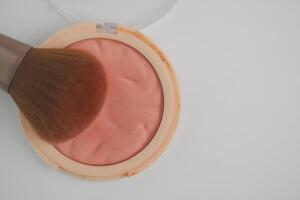 Blush application with brush on a smooth surface photo